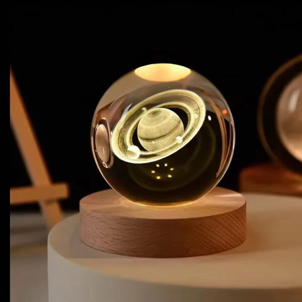 Crystal ball on a wooden base, Saturn